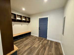 Mudroom featuring dark wood-style floors, electric panel, and recessed lighting