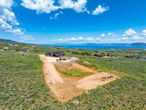 View of subject property with a water and mountain view