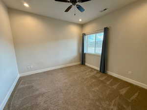 Carpeted spare room featuring recessed lighting and a ceiling fan