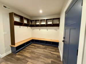 Mudroom featuring dark wood-style floors and baseboards