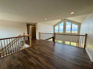 Bonus room with vaulted ceiling, dark wood-type flooring, and recessed lighting
