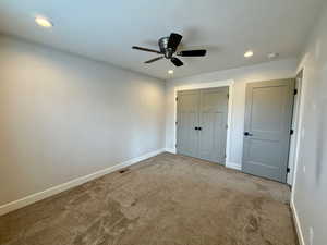 Unfurnished bedroom with carpet floors, a closet, recessed lighting, and a ceiling fan