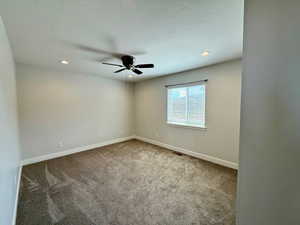 Unfurnished room featuring light colored carpet, recessed lighting, and a ceiling fan