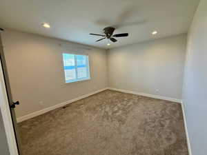 Empty room with carpet flooring, recessed lighting, and a ceiling fan