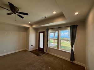 Entrance foyer featuring dark carpet, recessed lighting, and ceiling fan