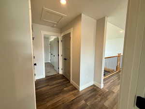 Hall with recessed lighting, dark wood-style floors, and attic access