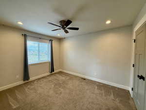 Carpeted empty room featuring recessed lighting and a ceiling fan