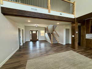 Entrance foyer featuring stairway, dark wood finished floors, and recessed lighting