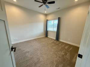 Spare room featuring carpet floors, recessed lighting, and ceiling fan