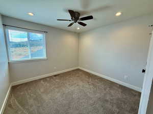 Carpeted empty room with recessed lighting and ceiling fan