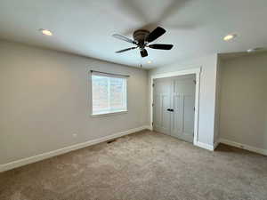 Unfurnished bedroom featuring carpet flooring, a closet, recessed lighting, and ceiling fan