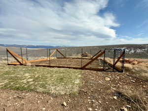 View of yard featuring a rural view and fence