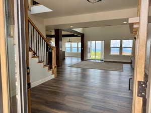 Entrance foyer with stairway, dark wood-style flooring, recessed lighting, and a chandelier