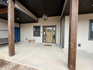 Doorway to property featuring a patio
