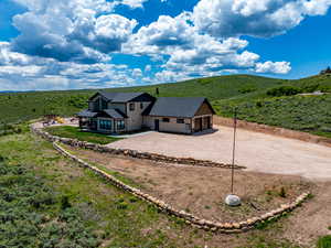 Aerial view of property and surrounding area featuring mountains