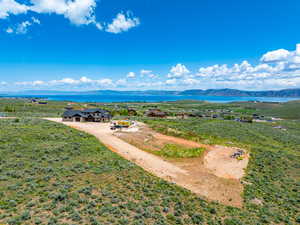 View from above of property with a water and mountain view