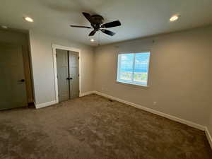 Unfurnished bedroom featuring carpet floors, recessed lighting, a closet, and a ceiling fan