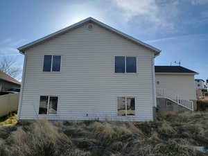 Rear view of house featuring fence
