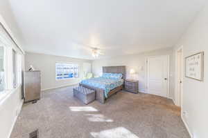 Bedroom with carpet floors and a ceiling fan