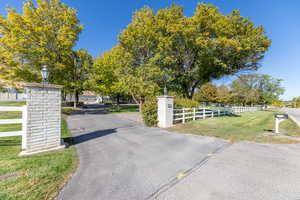 View of asphalt driveway with street lighting