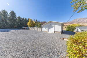 View of yard featuring an outdoor structure and a garage