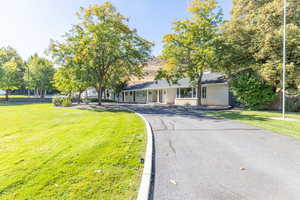 View of front of property featuring a front yard and brick siding