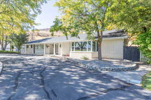 Ranch-style home featuring a porch and brick siding