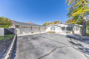 Ranch-style house with brick siding, asphalt driveway, and an attached garage