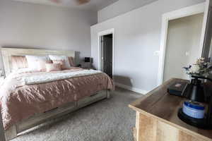 Carpeted bedroom featuring baseboards