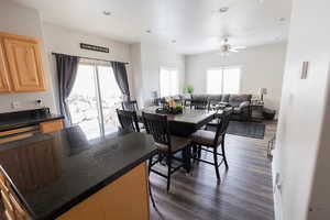 Dining area featuring dark wood-style flooring, a ceiling fan, plenty of natural light, and recessed lighting