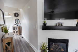 Hallway with baseboards and wood finished floors