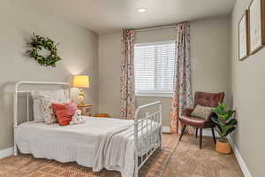 Carpeted bedroom with baseboards