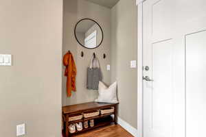 Mudroom featuring baseboards and light wood-type flooring