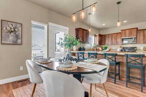 Dining space with baseboards, recessed lighting, and light wood-type flooring