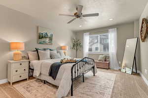 Bedroom featuring recessed lighting, baseboards, a textured ceiling, a ceiling fan, and light carpet