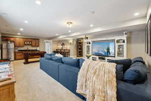 Living room with recessed lighting, and light colored carpet