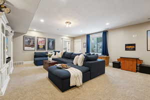 Living room featuring light colored carpet, recessed lighting and a separate entry.
