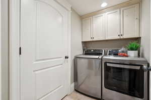 Laundry Room featuring light tile patterned flooring, cabinet space and recessed lighting.