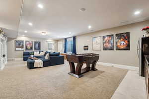 Living room featuring light colored carpet, recessed lighting and a separate entry.