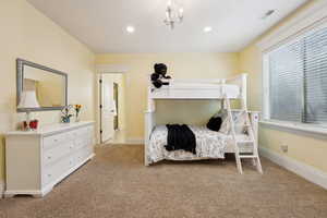 Bedroom with light colored carpet and recessed lighting