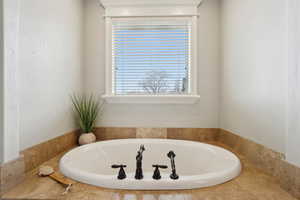 Primary Ensuite Bathroom featuring a garden tub