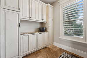 Laundry room with loads of cabinet space.