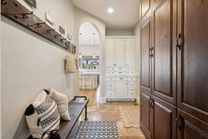 Mud room off of garage with tons of storage including lockers, coat hooks and bench.