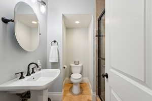 Bathroom with tile patterned flooring, and a stall shower