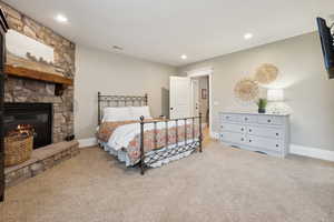 Bedroom with carpet floors, a fireplace, a huge closet and recessed lighting