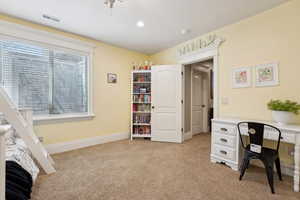 Bedroom with light colored carpet and recessed lighting