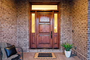 Large entry porch with massive solid wood door welcomes you home