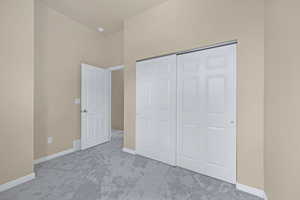 Unfurnished bedroom featuring a closet, visible vents, baseboards, and carpet floors