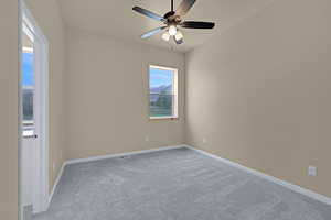 Empty room with visible vents, ceiling fan, light carpet, and baseboards