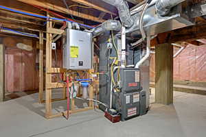 Utility room featuring heating unit and tankless water heater